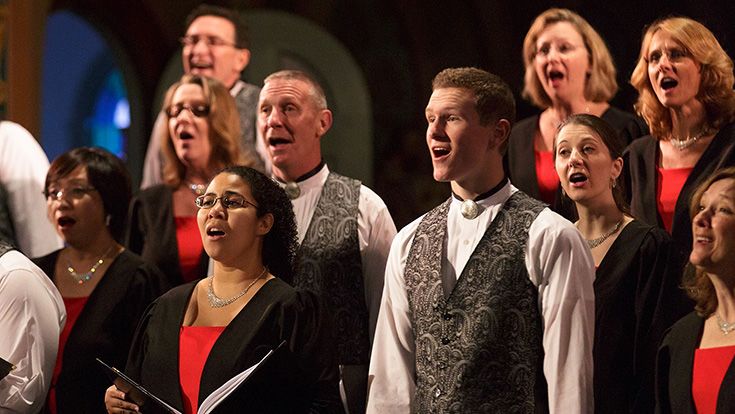A group of choral singers performing on stage
