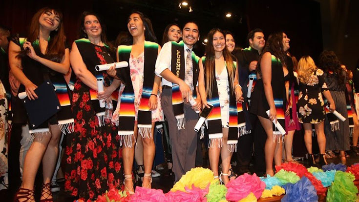Students in graduation regalia at a Honrando a Nuestros Estudiantes celebration